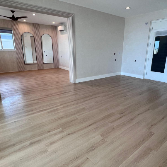 Room featuring double glass patio doors and a decorative entrance with wood slats.